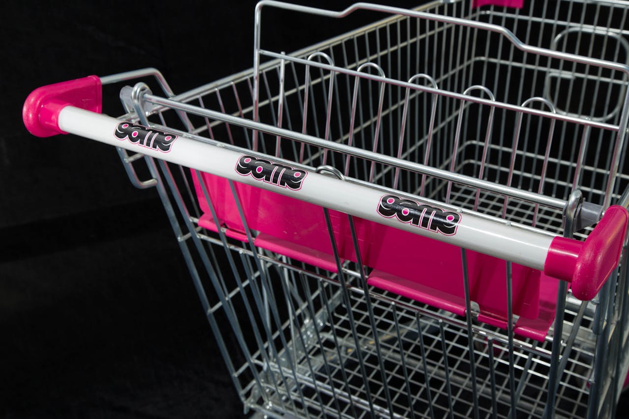 Detailed image of a shopping cart with vibrant pink highlights and brand logos.